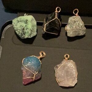 Raw stone crystal pendants .